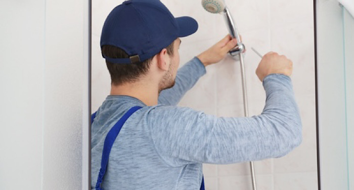 man installing shower head