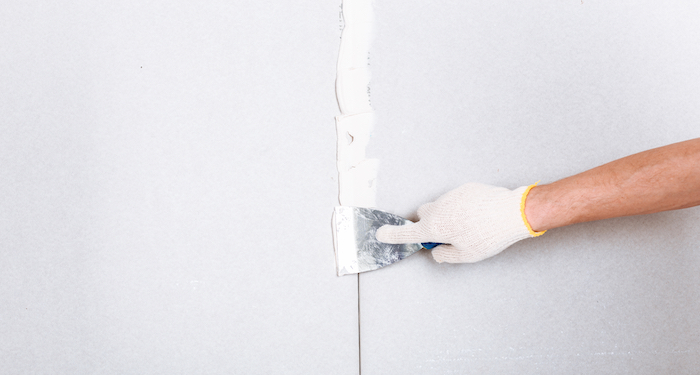 tradesperson installing dry wall