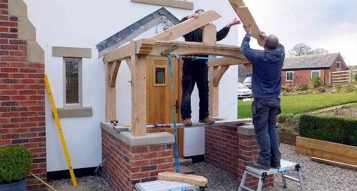 Tradespeople removing a porch