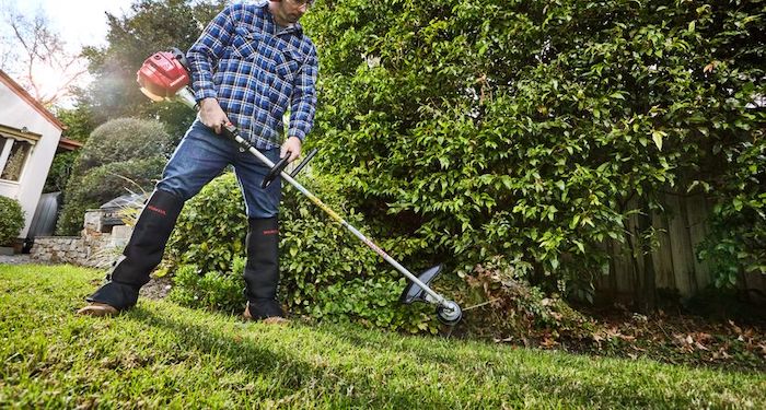 Using a petrol strimmer