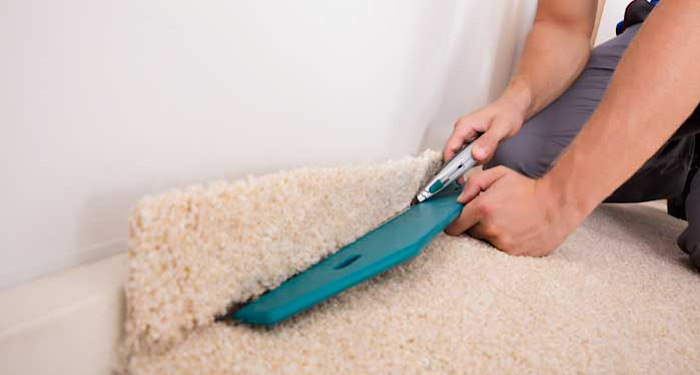 person fitting a cream carpet