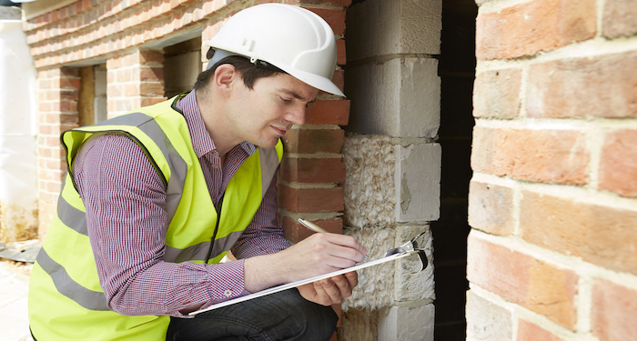 Man surveying property walls