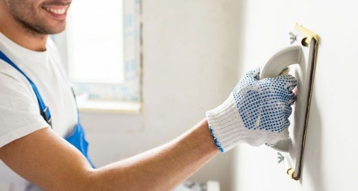 Man removing wall artex