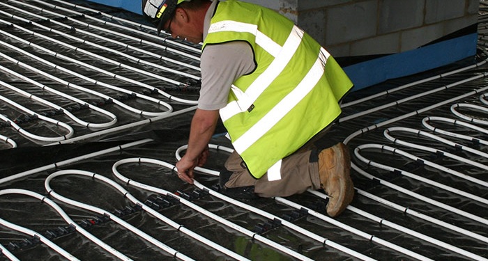 tradesperson installing underfloor heating