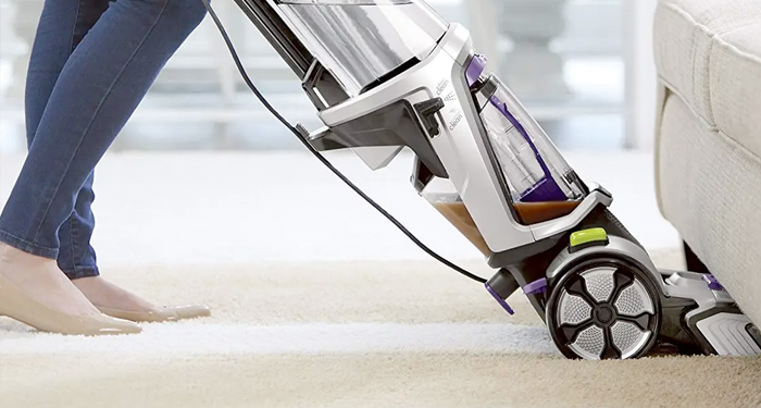 Silver and black carpet steamer on cream carpet