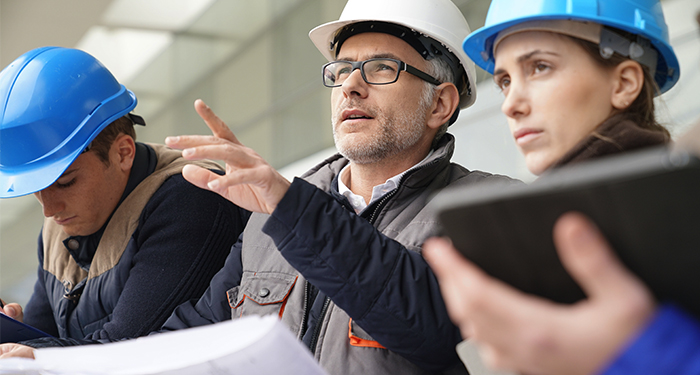 2 engineers surveying building