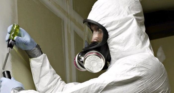 Man removing chemical artex