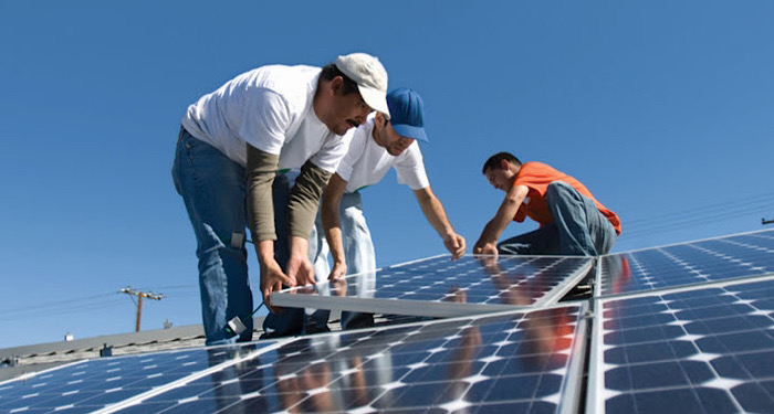 men installing solar panels