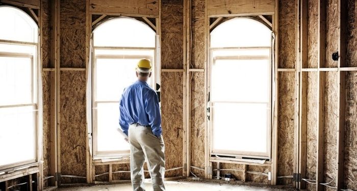 tradesman looking at internal house renovations