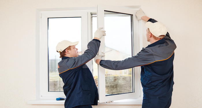 tradperson installing triple glazing