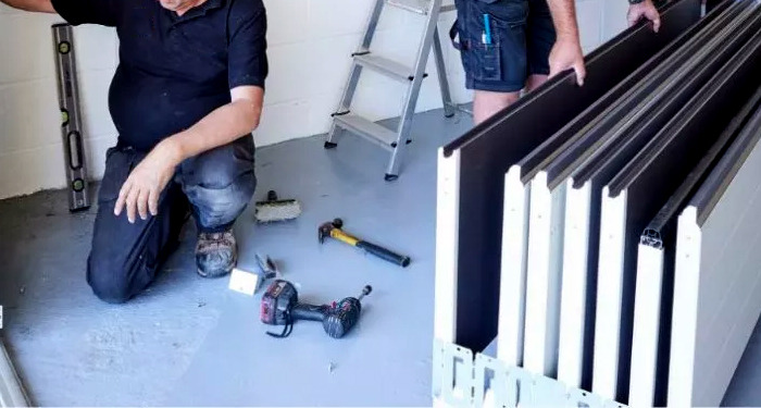 workmen installing a garage