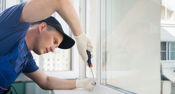 man repairing a window
