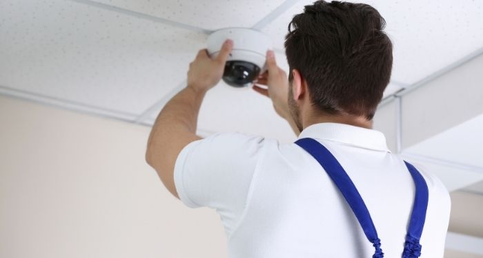 Man installing security camera on camera