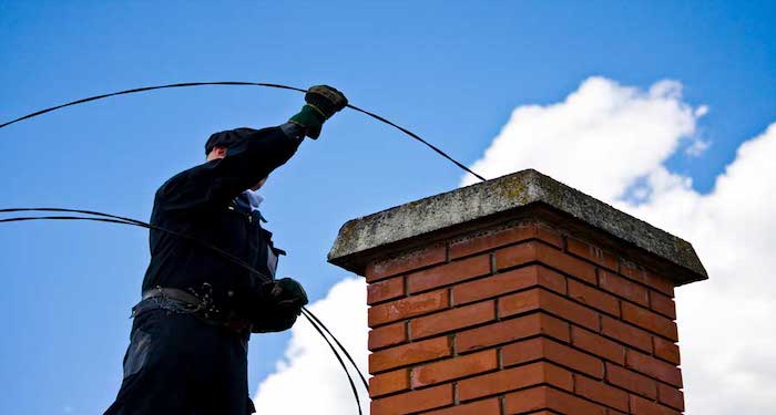 Chimney sweep on roof