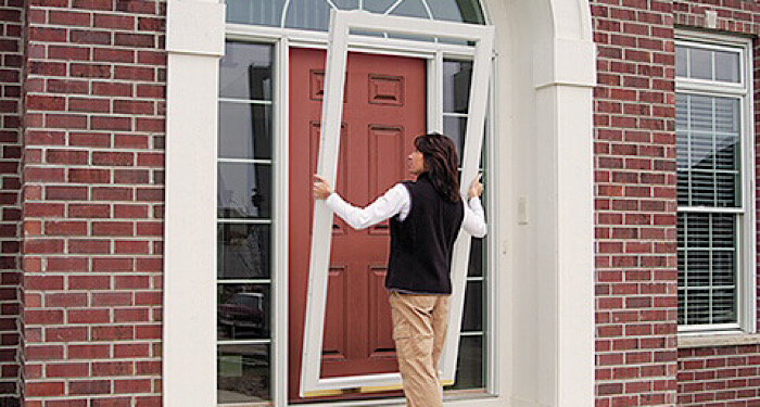 woman installing front door frame