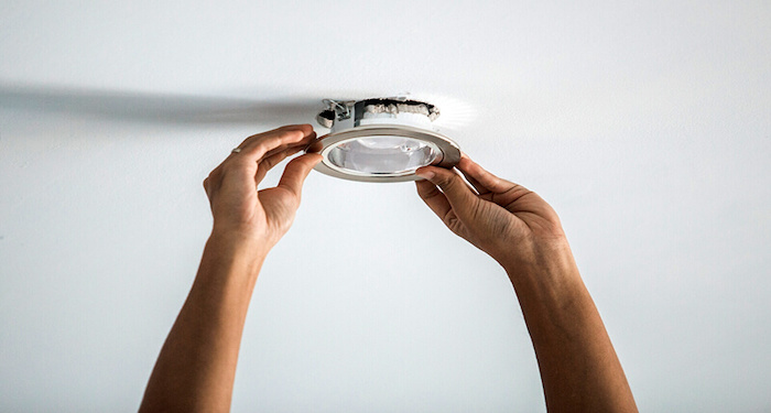 person installing a ceiling light