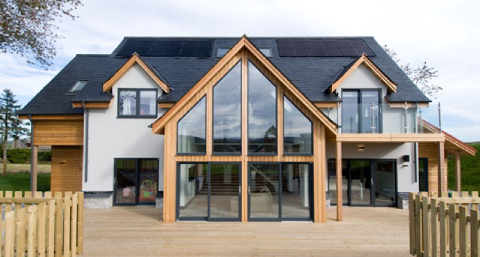 big house with large windows and decking