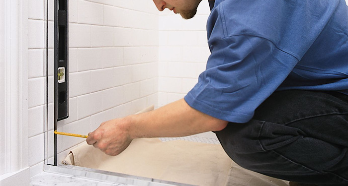 man measuring shower