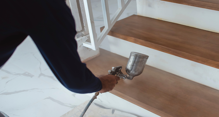 tradesman painting stairs