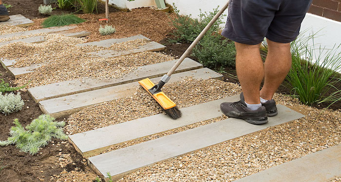 man brushing gravel