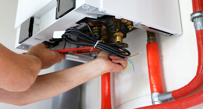 tradesmen installing boiler