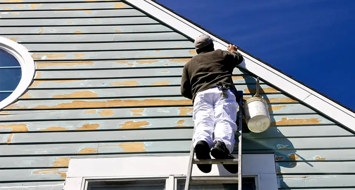 man painting house