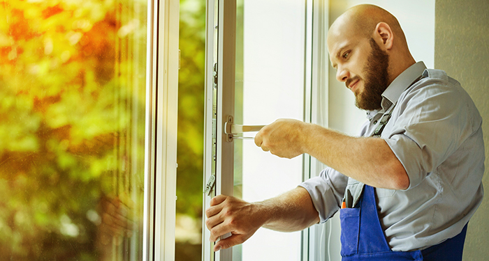 workman checking lock on door