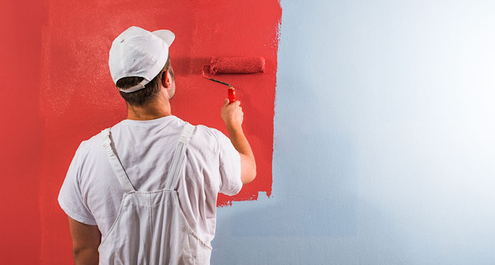 painter painting wall red
