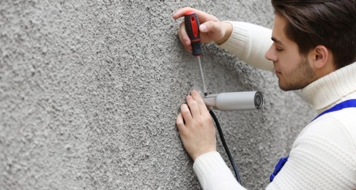 Man removing CCTV system