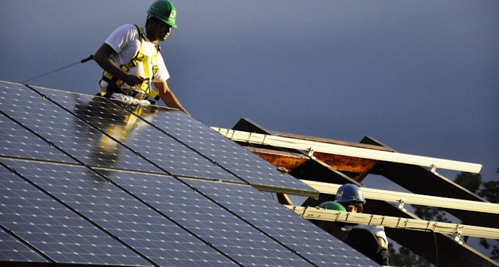 two workmen installing solar panels