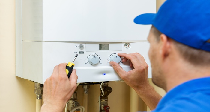 Man fitting boiler