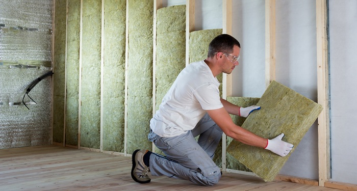 man installing loft insulation