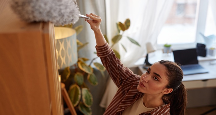 Woman cleaning cupboards