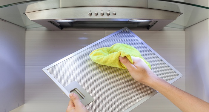 Hands cleaning cooker hood