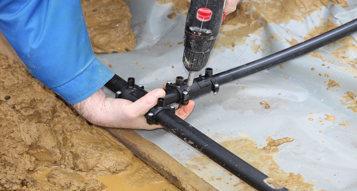 Man installing GSHP