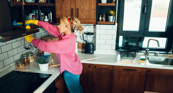 Woman cleaning cupboards