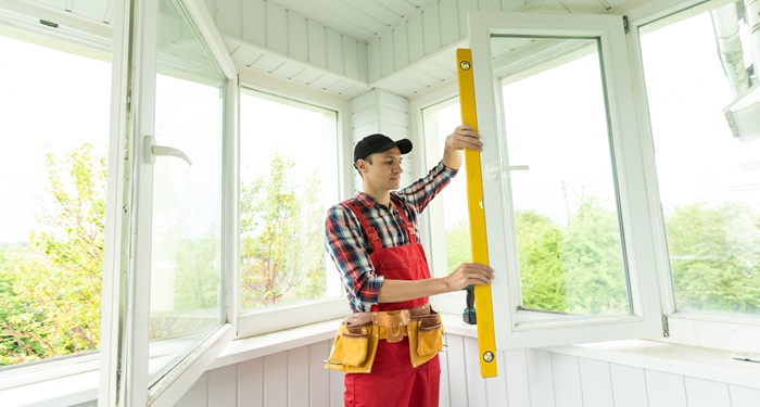 Man measuring for blinds