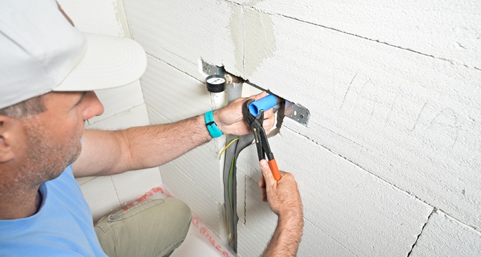 Plumber installing pipes