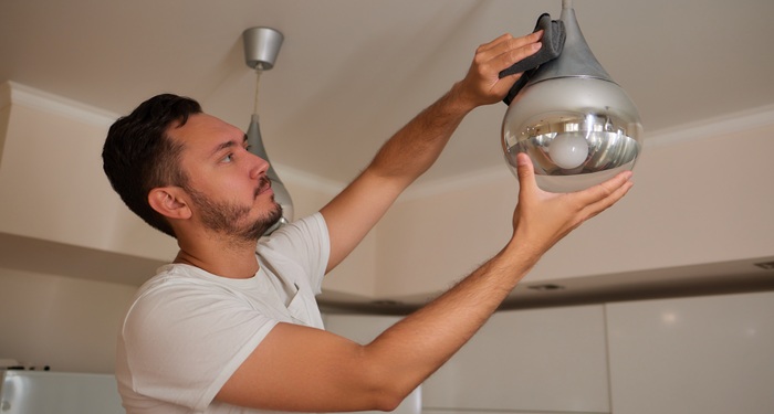 Man dusting lights