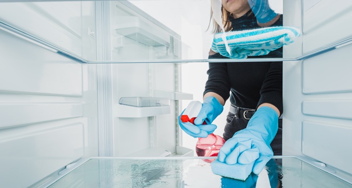 Hand cleaning fridge out