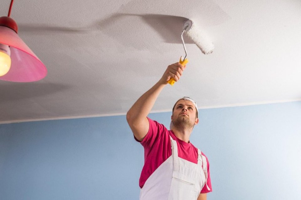 man painting ceiling