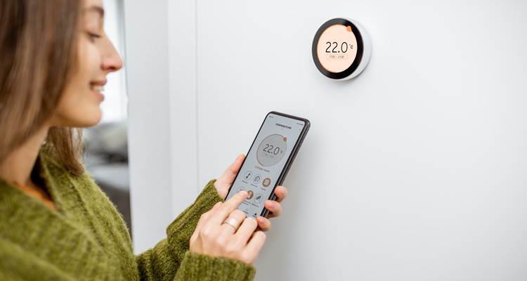 Woman with smart thermostat