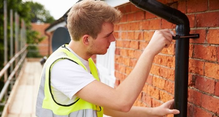 Man repairing guttering