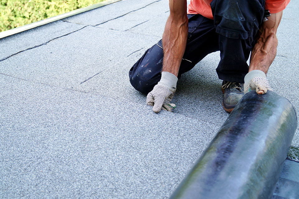 man replacing flat roof