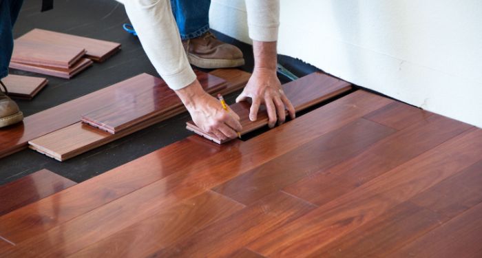 person installing wood flooring