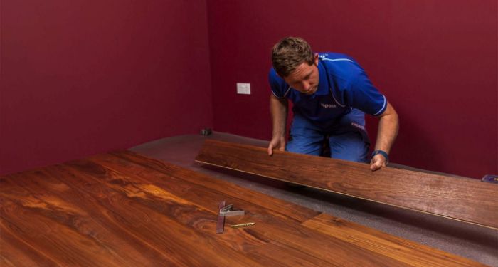 man installing hardwooding flooring