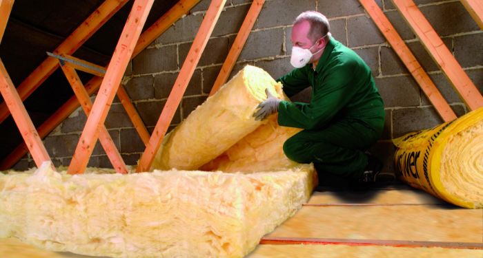 person installing loft insulation