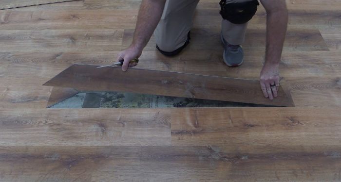 man removing lvt flooring