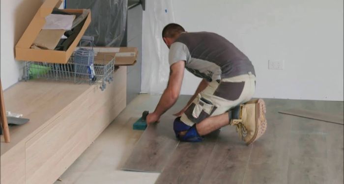 man installing lvt flooring