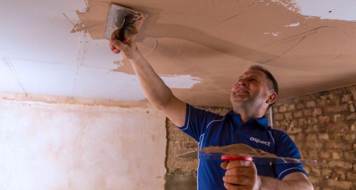 plasterer plastering a ceiling